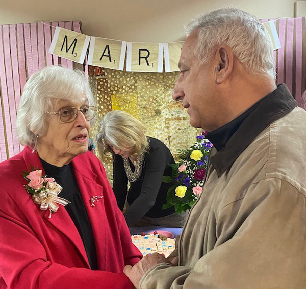 Richard Gerentine congratulates Marian Baldwin on her 100th birthday.